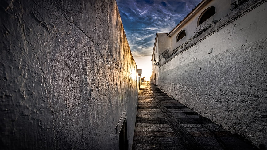 Narrow stone staircase in old town at sunset