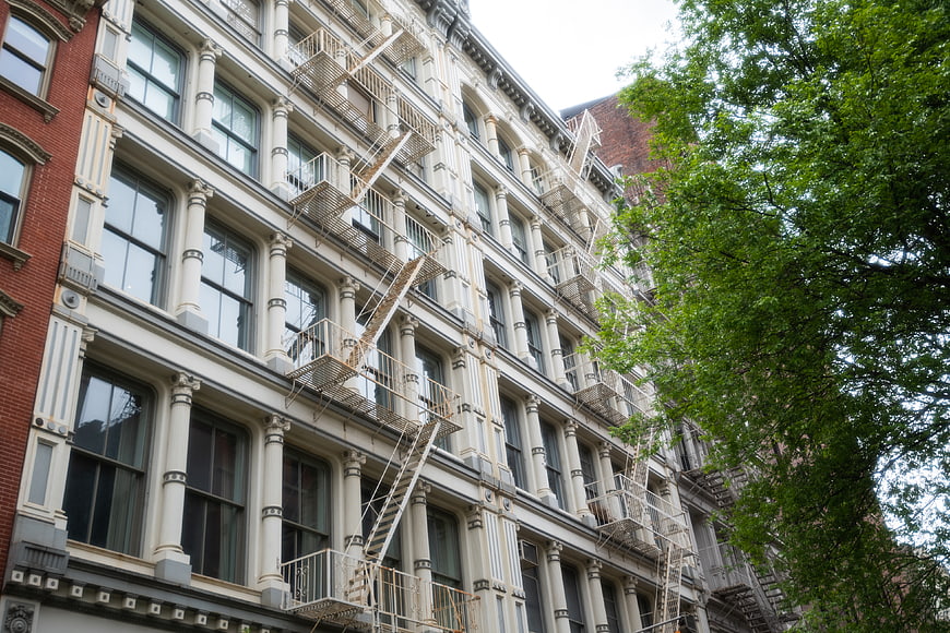 Low angle view of historic apartment building with fire escapes
