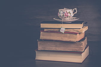Vintage Books Stack with Floral Tea Cup and Tea Bag