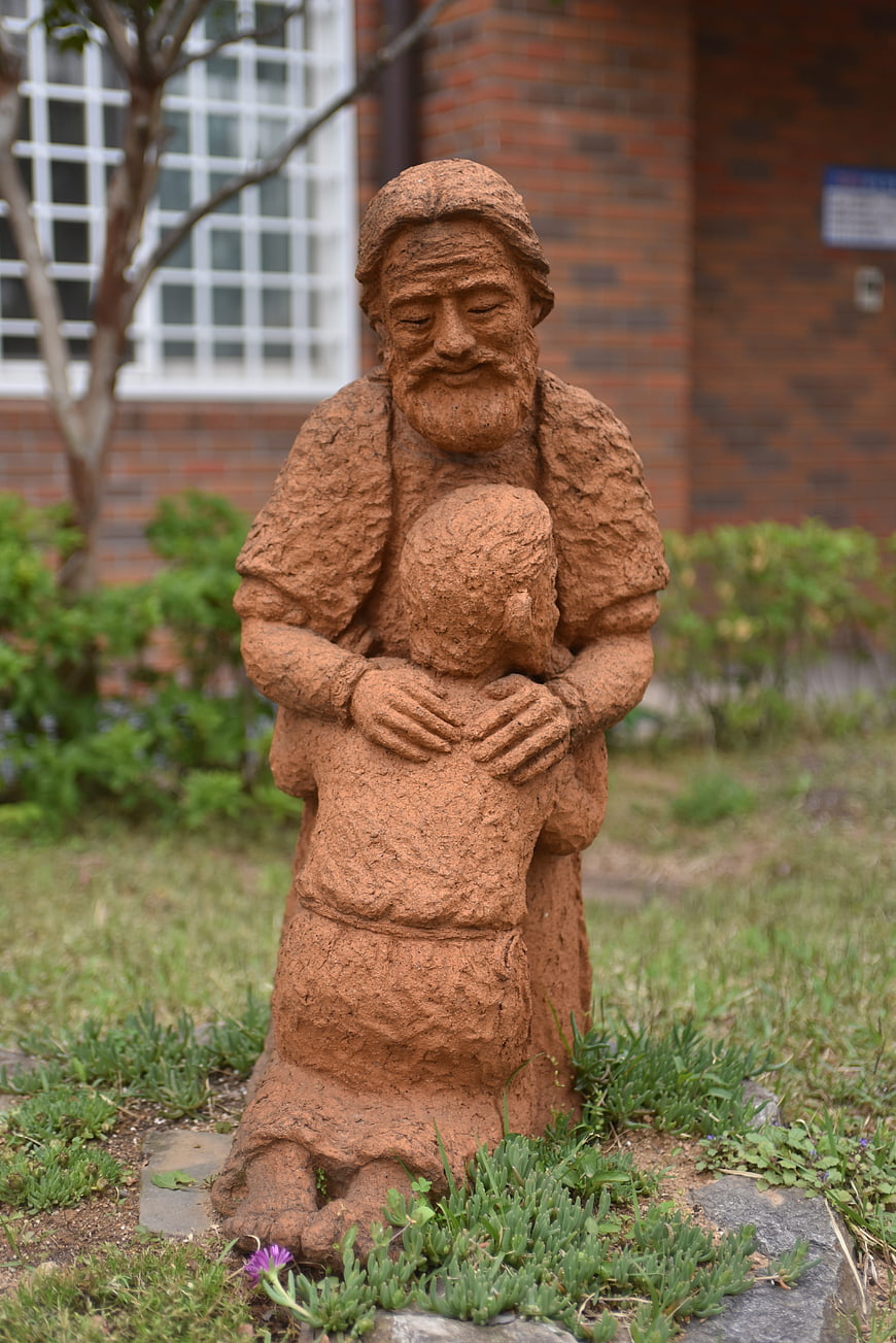 Terracotta Statue of Father Embracing Kneeling Son