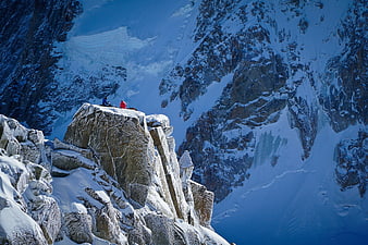 Two climbers resting on snowy mountain peak