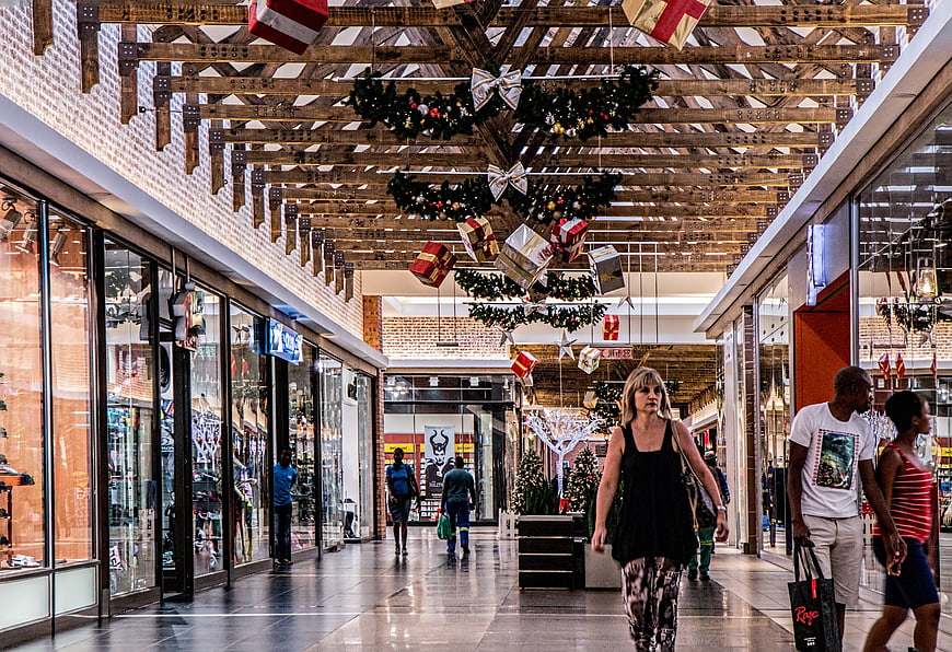 Christmas Shopping Mall Interior with Decorations and Shoppers
