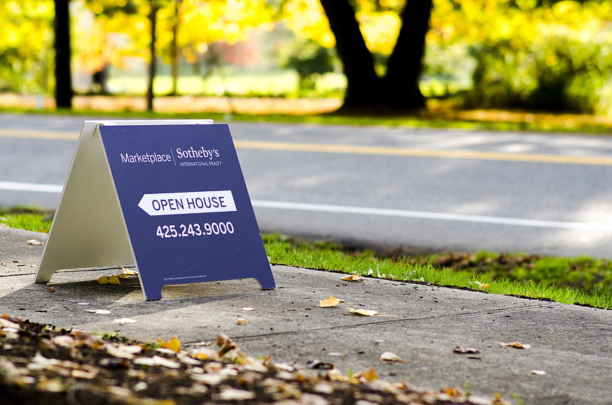 Blue Real Estate Open House Sign On Sidewalk