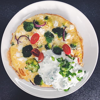 Overhead shot of vegetable omelet with yogurt sauce