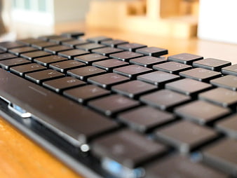 Close-up of black computer keyboard on wooden desk