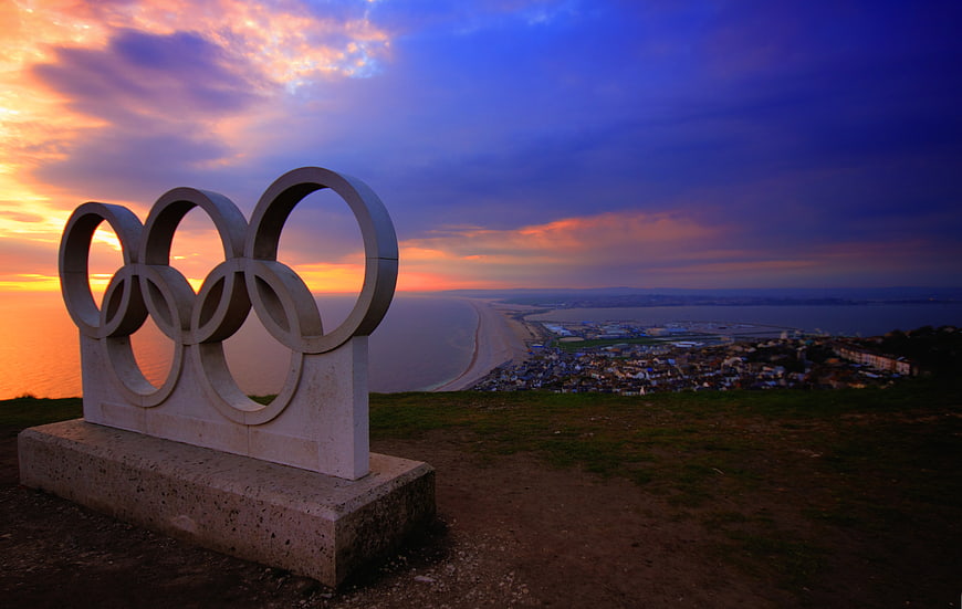 Olympic Rings Sculpture at Sunset Over Weymouth Coast
