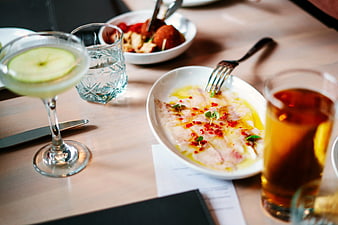 Gourmet Carpaccio and Cocktails on Wooden Table