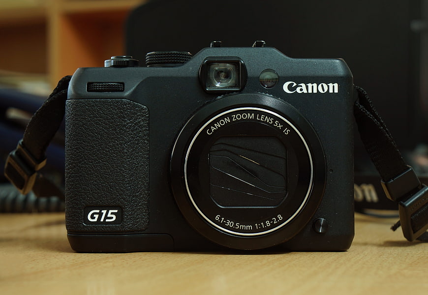 Black Canon PowerShot G15 Digital Camera on Wooden Desk