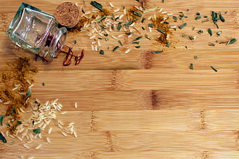 Saffron, rice, and herbs on a wooden cutting board