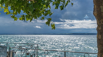 Dramatic Lake View with Stormy Sky and Sunlit Water