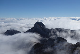 Majestic mountain peaks rising above a sea of clouds
