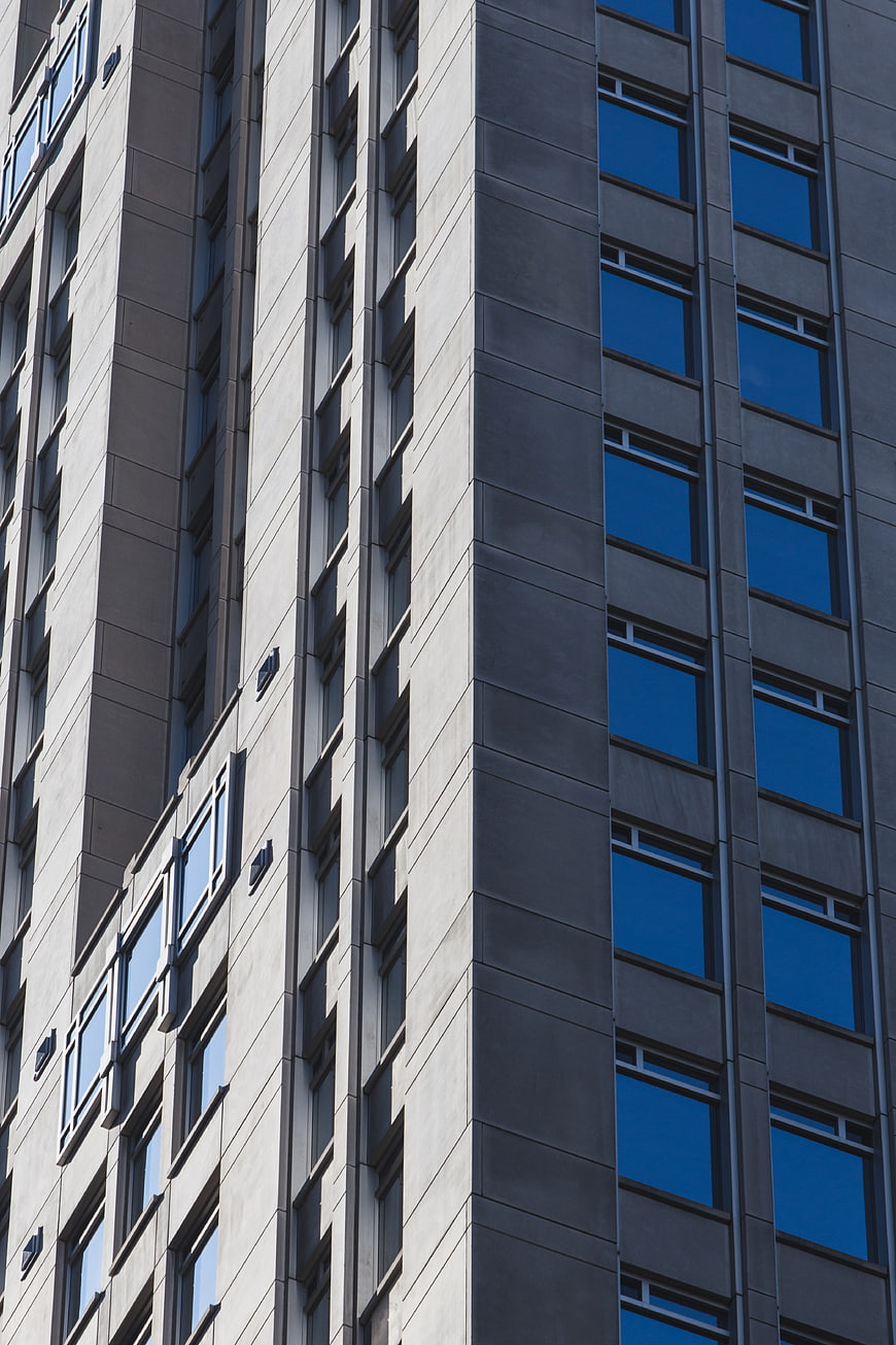 Modern Concrete Building Facade with Blue Windows