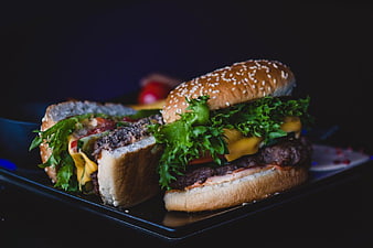 Gourmet Cheeseburger Cut in Half on Black Plate