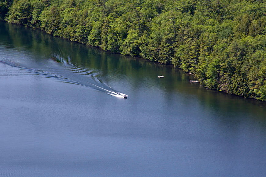 Aerial View of Speedboat on Lake with Forest Shoreline