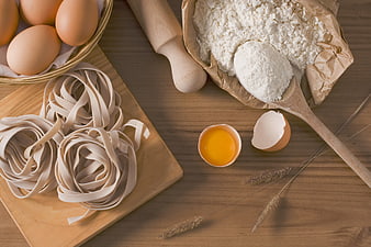 Fresh pasta ingredients flat lay with flour and eggs