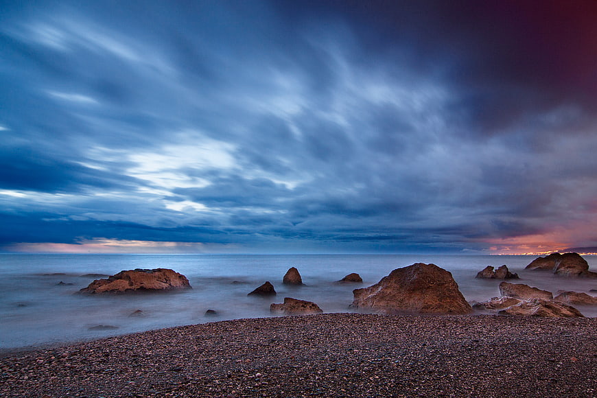 Dramatic Long Exposure Seascape with Rocks and Clouds