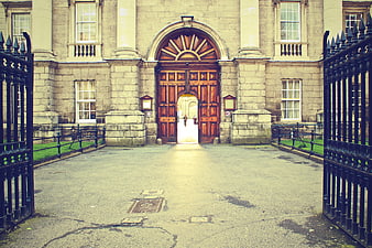 Grand stone building entrance with open wooden gates