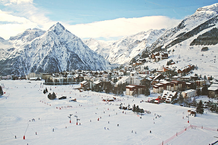Wide View of Snowy Ski Resort Village in Alpine Mountains