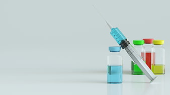 Medical syringe and colorful medicine bottles on white background