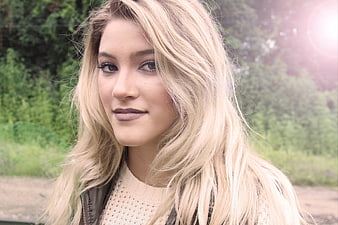 Portrait of Young Blonde Woman with Sun Flare Outdoors