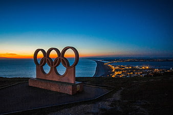 Olympic Rings Sculpture at Sunset Over Portland Coastline