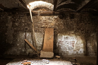 Abandoned Industrial Basement Interior With Exposed Brick Walls And Debris