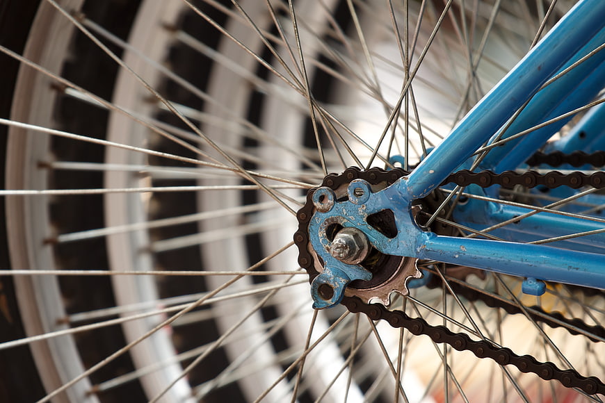 Close-up of vintage blue bicycle wheel and chain mechanism