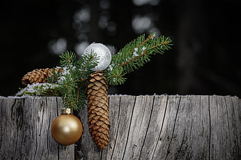 Winter Christmas Decoration With Pine Cones And Ornaments On Weathered Wood