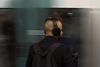 Man with headphones waiting for subway train