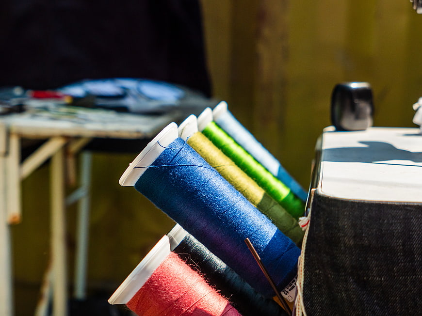 Colorful Sewing Thread Spools in a Workshop