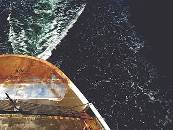 Rusty Boat Bow Cutting Through Dark Ocean Water