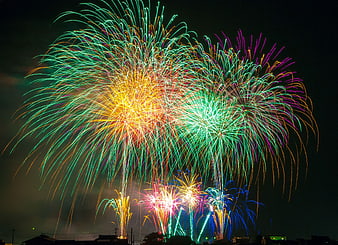 Vibrant Multi-Color Fireworks Display Over Night Sky