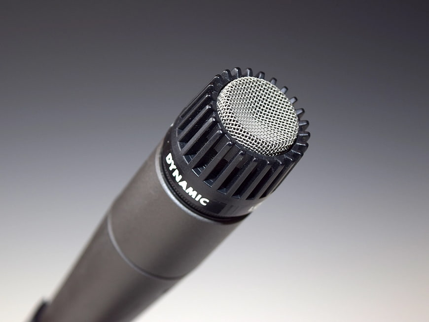 Close-up of black dynamic microphone on gray background