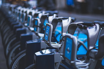 Row of blue Barclays rental bicycles at docking station