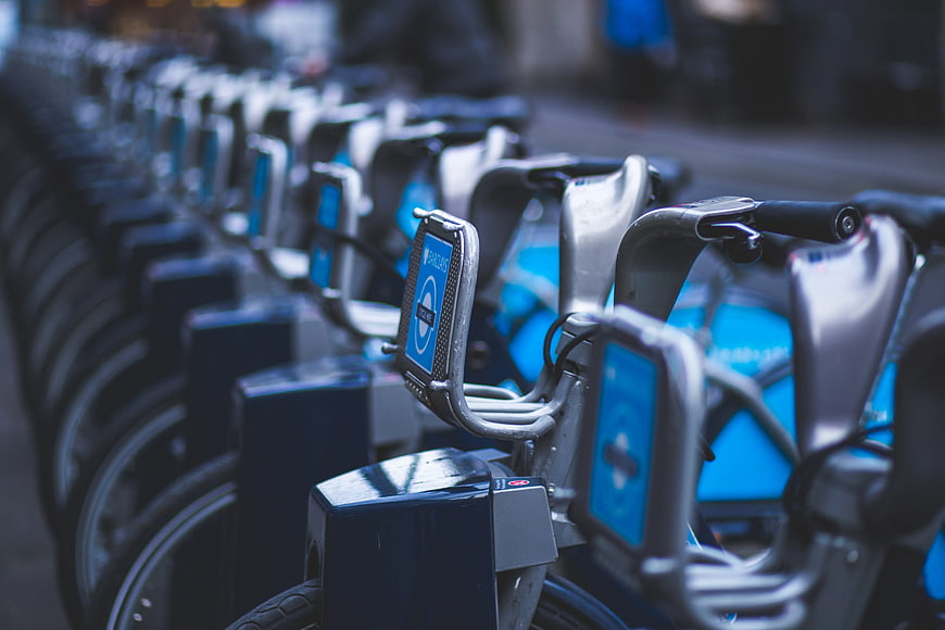 Row of blue Barclays rental bicycles at docking station