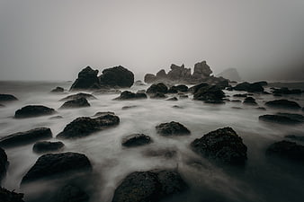Misty Rocky Shoreline with Long Exposure Ocean Waves
