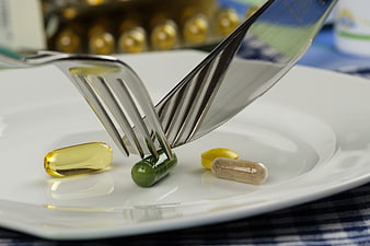 Supplements on Plate with Fork and Knife