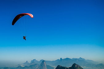 Paraglider soaring over Rio de Janeiro mountains