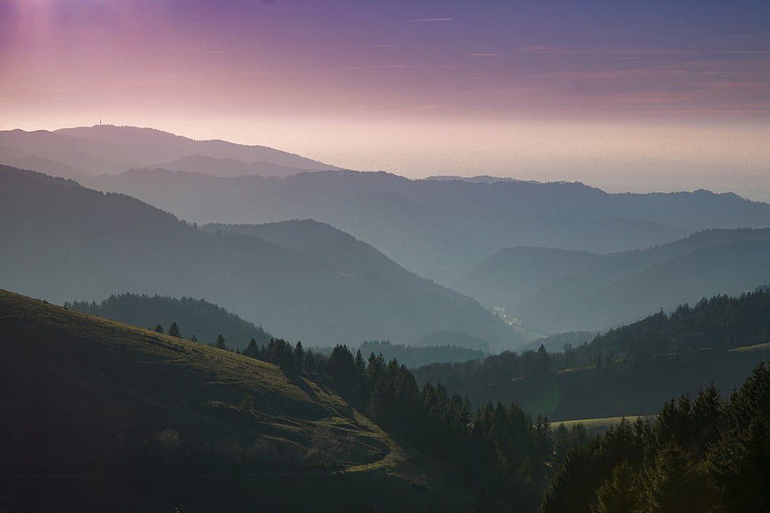 Misty Mountain Valley at Sunset with Purple Sky