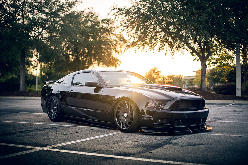 Black Modified Mustang Coupe Parked at Sunset