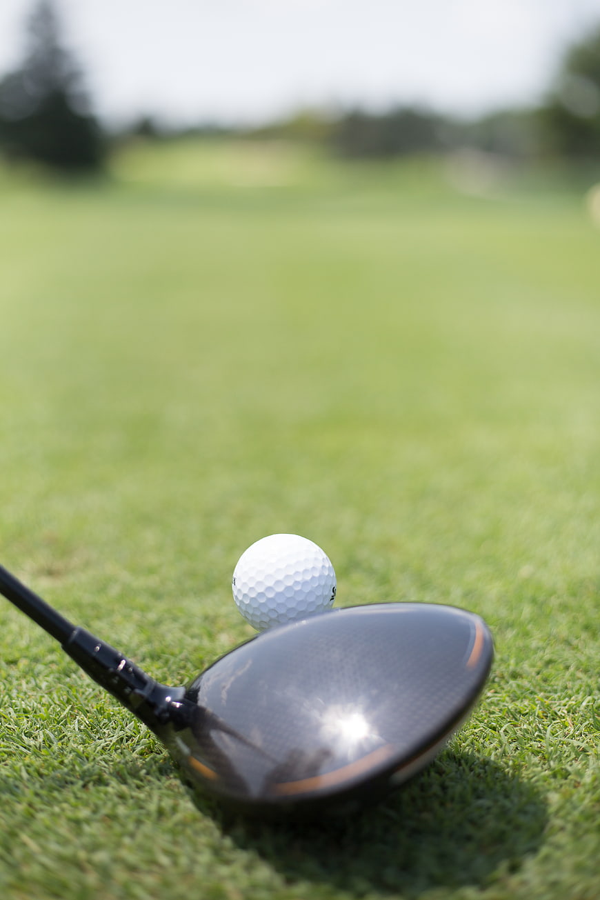 Golf Driver and Ball on Green Grass Course