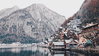 Traditional Alpine Village on Lake Shore with Mountains