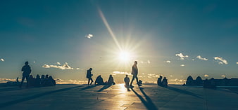 Silhouettes of People on Oslo Opera House at Sunset
