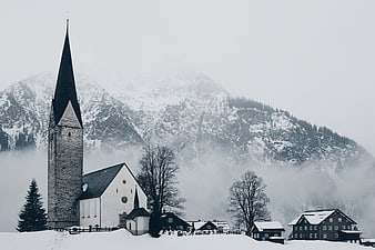 Snowy Church and Village in Alpine Winter Landscape