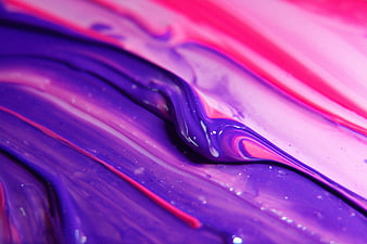 Abstract macro texture of swirling purple and pink acrylic paint