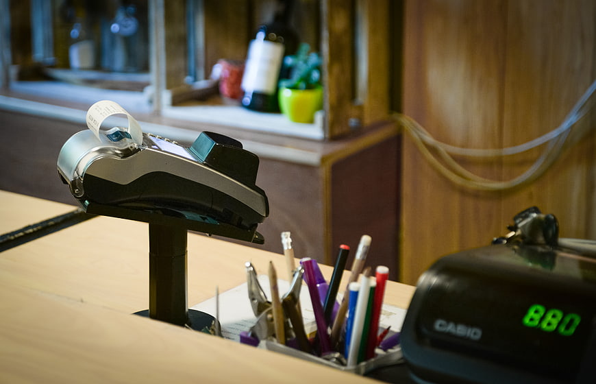 Credit card payment terminal on wooden counter