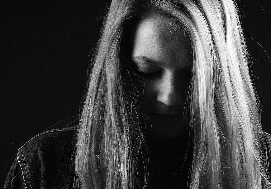 Melancholic black and white portrait of a woman with long hair