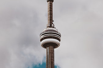 CN Tower Upper Section Against Cloudy Sky