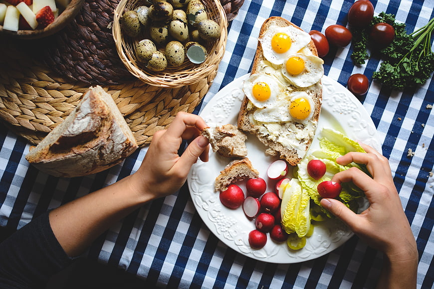 Top view of Easter breakfast with fried quail eggs on bread