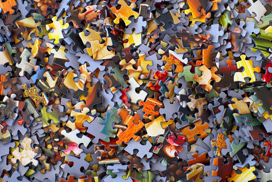 Scattered Jigsaw Puzzle Pieces Background